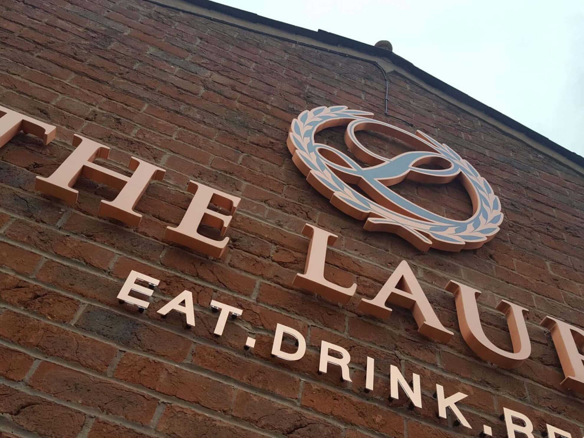 The Laurels sign - Halo illuminated premium build up 3D letters and logo with flat cut copper letters on stand off locators