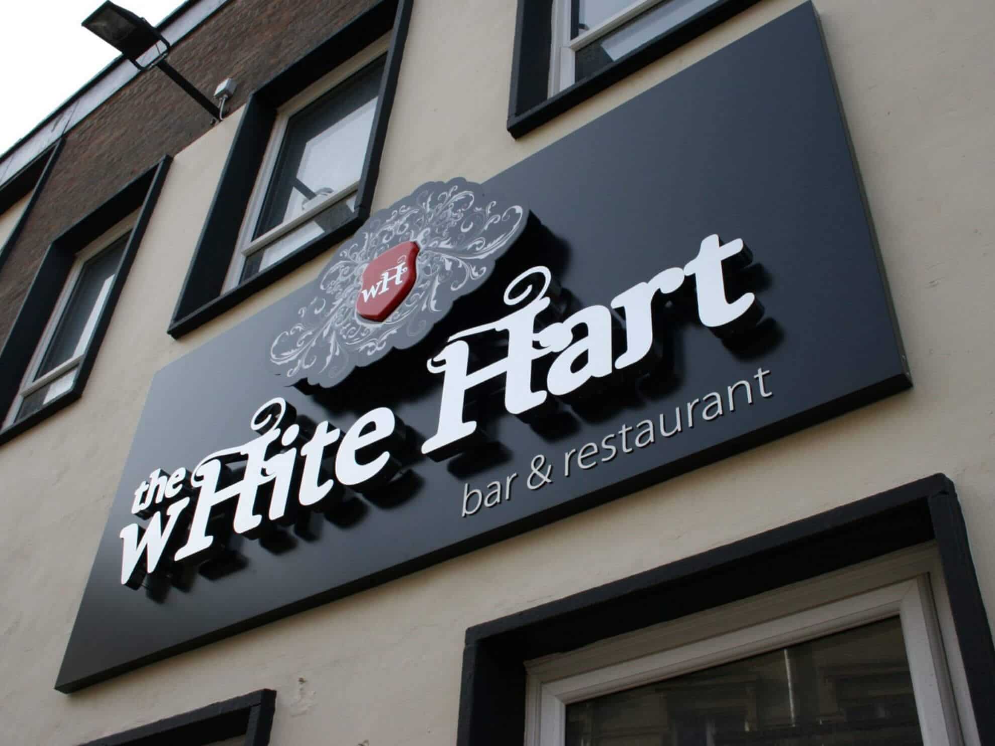 the wHite Hart sign - 3D built up poly stainless steel letters with white LED halo illumination and feature logo